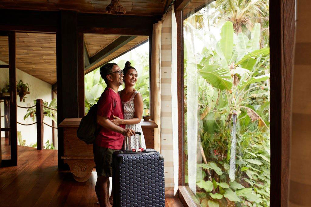 Traveller arriving at a tropical destination with luggage