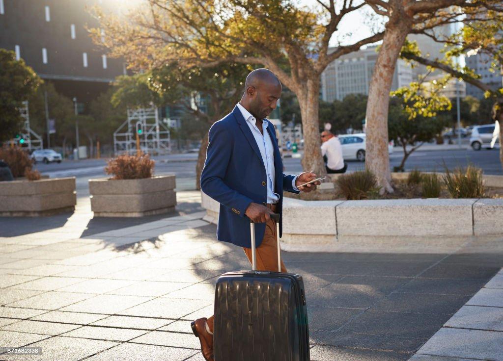 Traveller walking through an airport terminal with luggage